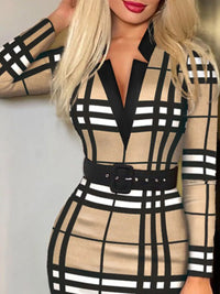 Woman wearing a black and beige checkered dress with a belt.