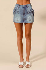 Denim skirt worn by a person on a beige background