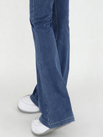 Blue jeans worn by a person on a white background