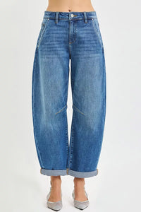 Blue jeans worn by a person on a white background