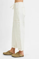 White pants worn by a person on a white background