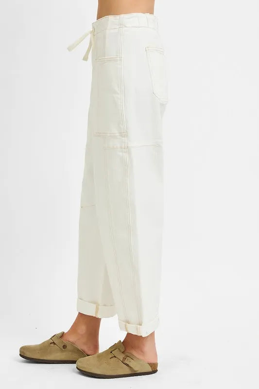 White pants worn by a person on a white background