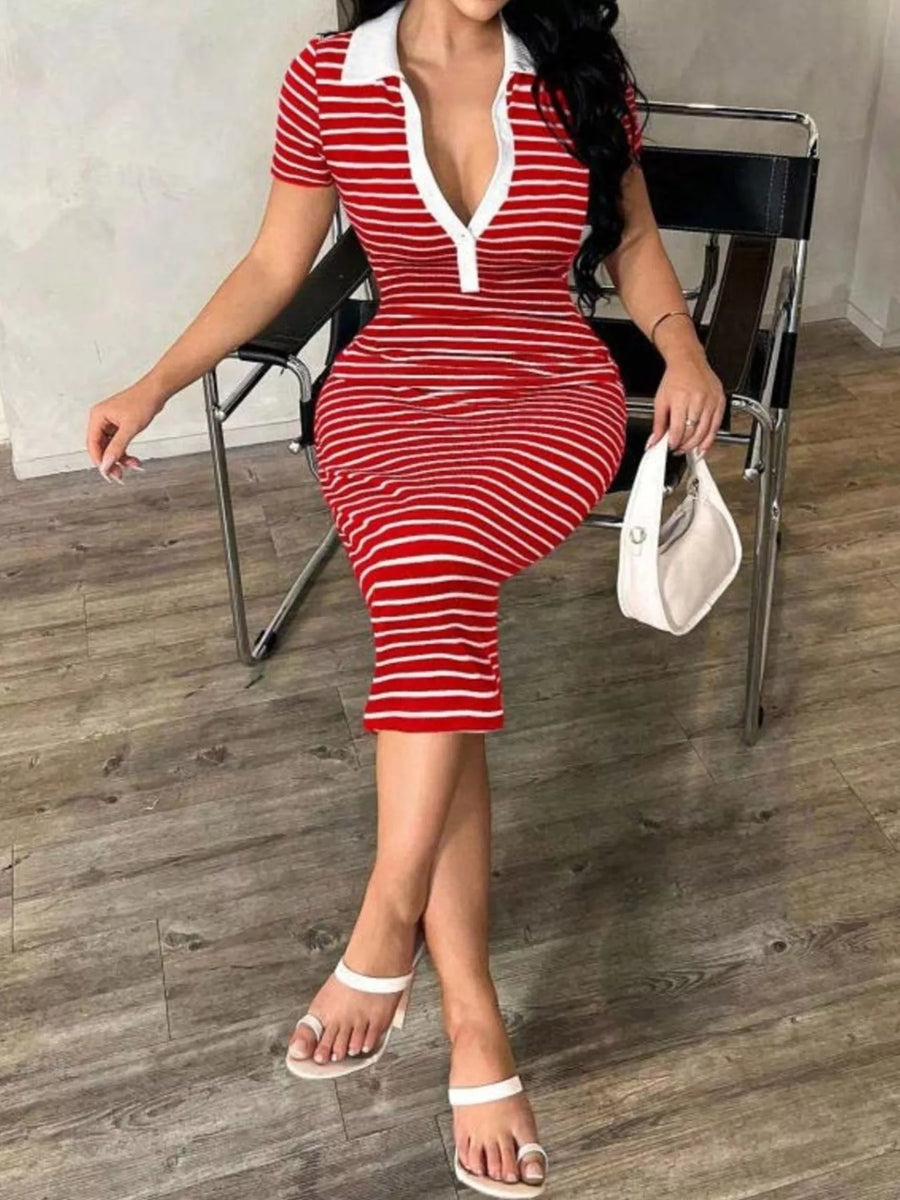 Woman in a red and white striped dress sitting on a chair.
