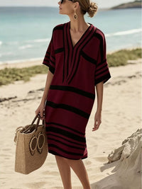 woman wearing burgundy and black striped dress
