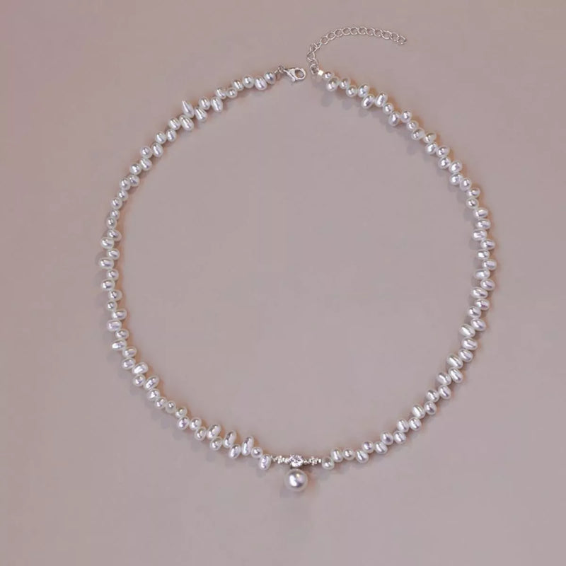 Pearl necklace on a beige background