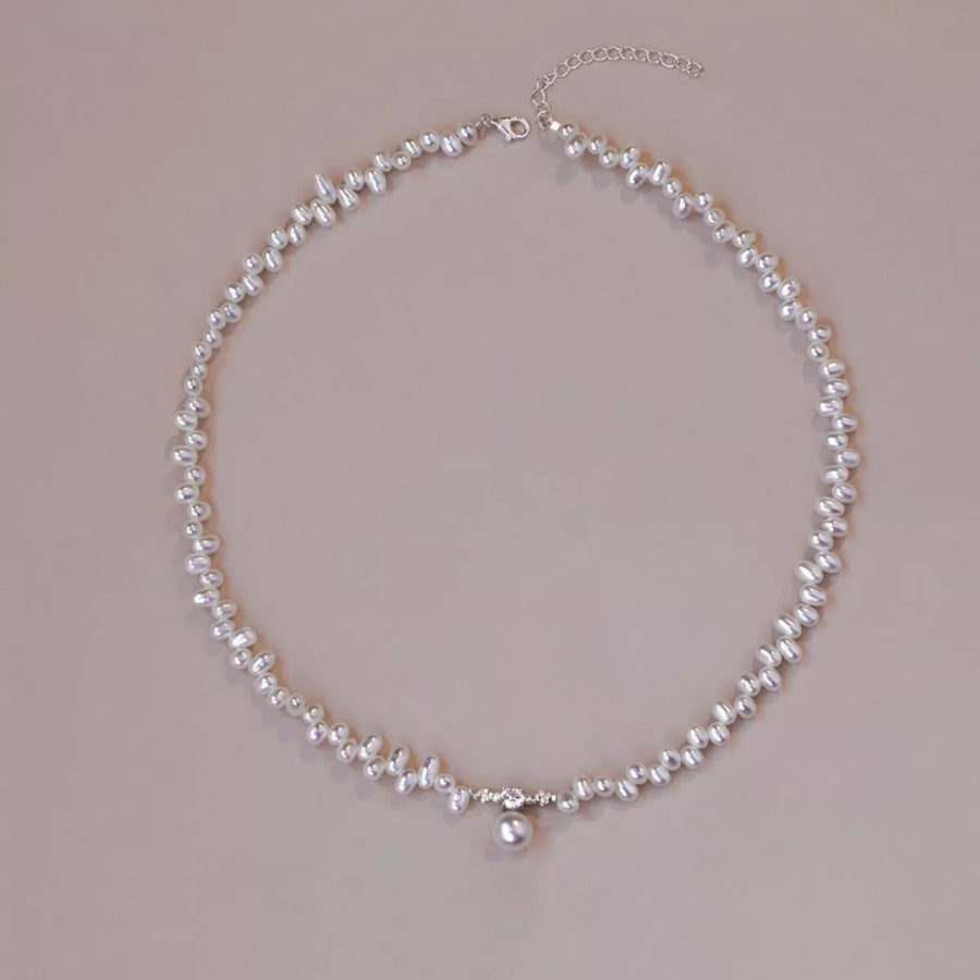 Pearl necklace on a beige background