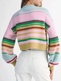 Multicolored striped sweater worn by a person on a white background