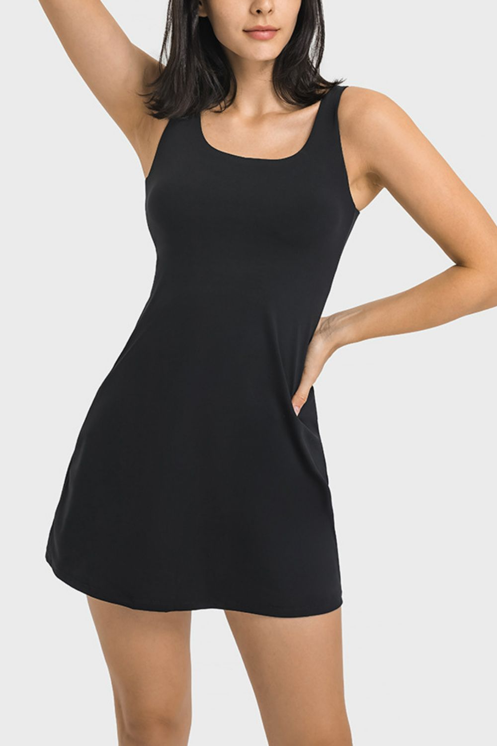 Black sleeveless dress worn by a model on a white background