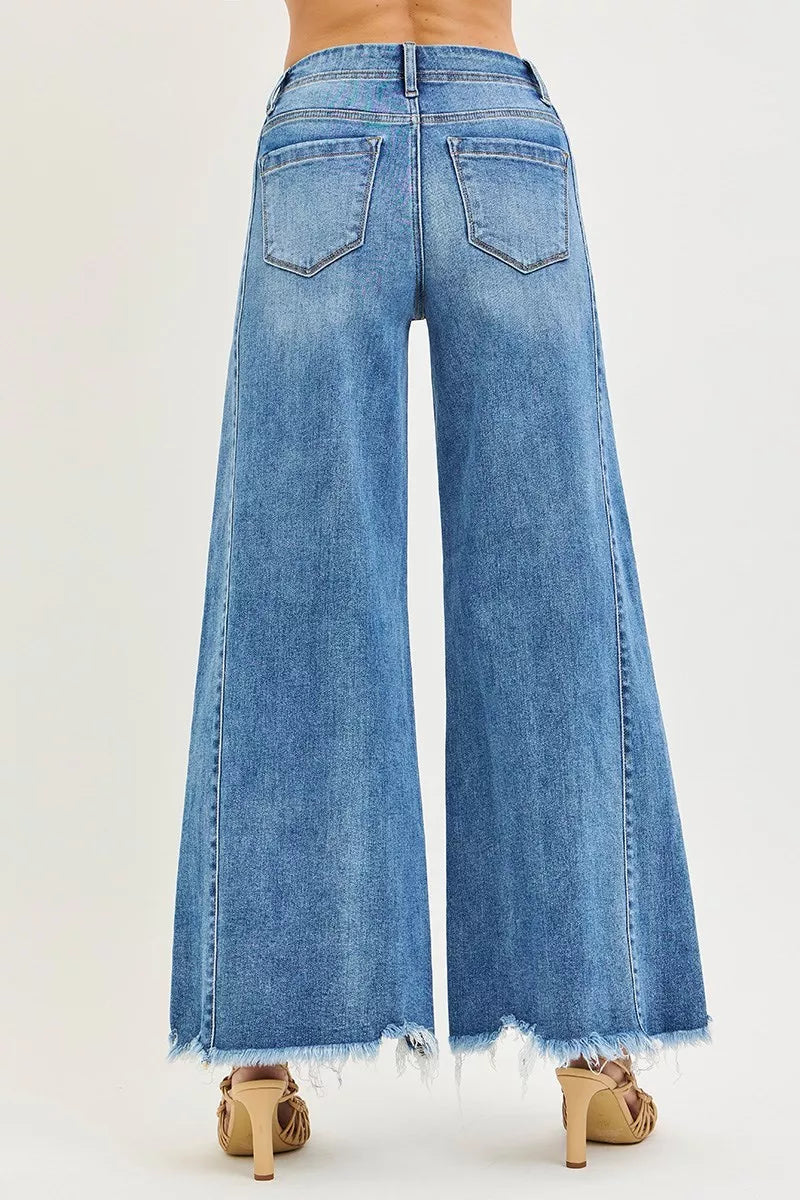 Blue denim wide-leg jeans on a plain background