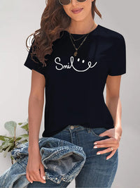 Person wearing a black t-shirt with 'Smile' text and smiling face design.