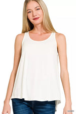 Woman wearing a white sleeveless top on a white background
