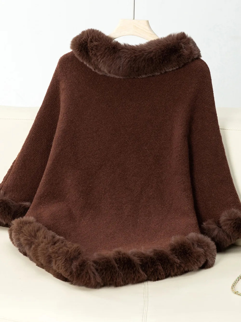 Brown fur-trimmed poncho on a white background