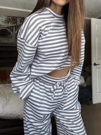 Person wearing a gray and white striped outfit in a room.