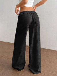 Model showing the back of Full Size Drawstring Wide Leg Pants Plus Size