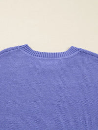 Close-up of a blue sweater on a beige background