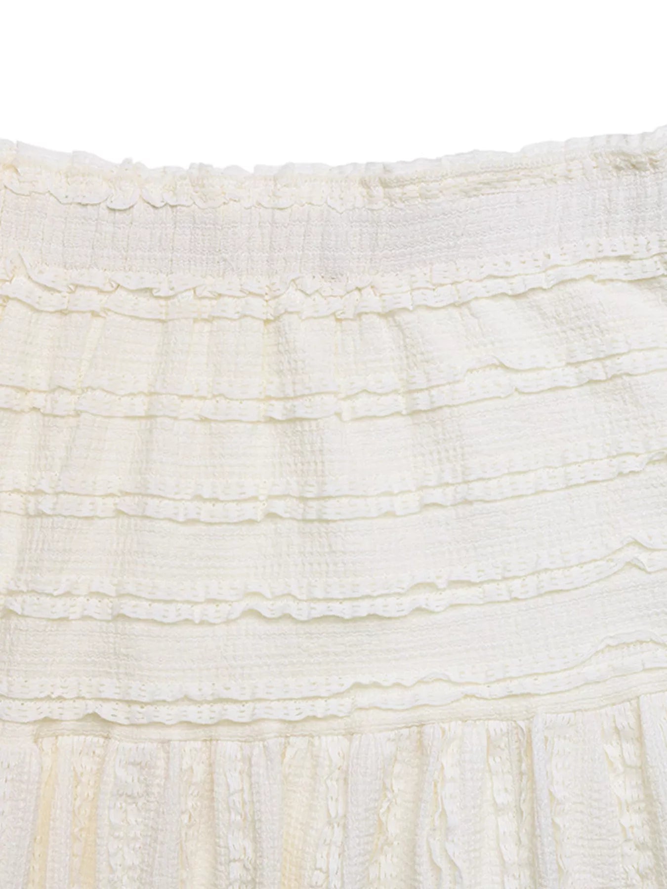 Close-up of textured white fabric with ruffled edge
