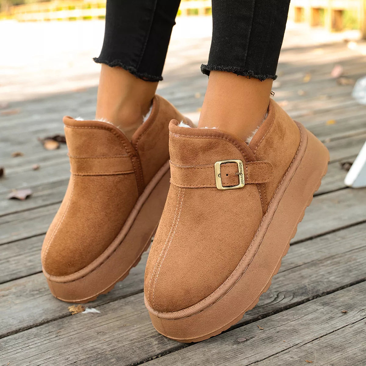 Woman showing A pair of baige Round Toe Platform Boots 