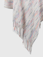 Multicolored striped poncho with fringe on a light gray background