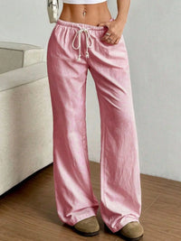 Person wearing pink striped pants in a casual setting