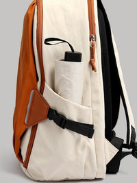 Beige backpack with brown leather accents on a gray background