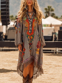 Woman wearing a colorful bohemian dress with fringe at an outdoor event.