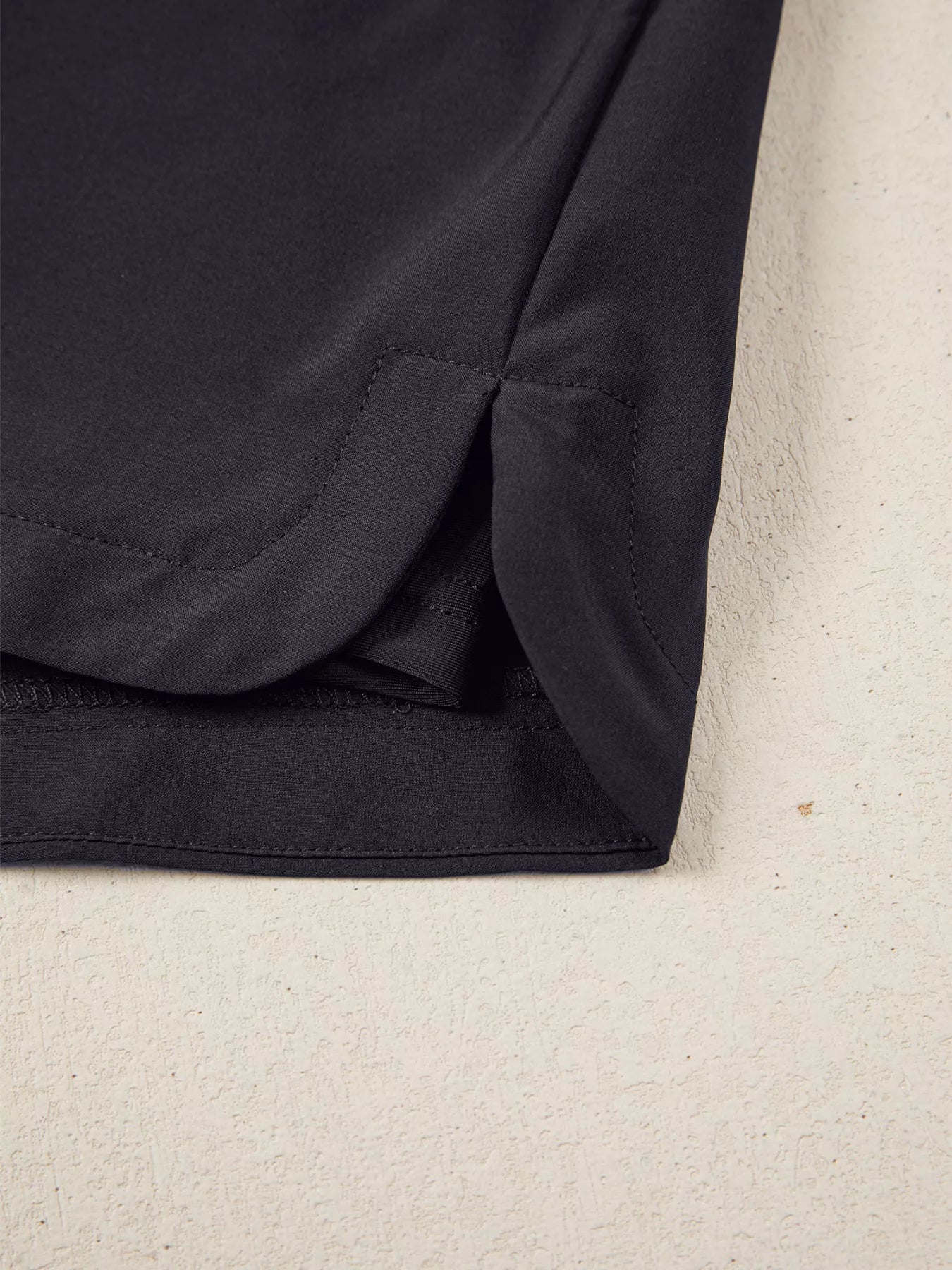 Close-up of a dark blue fabric corner on a beige background