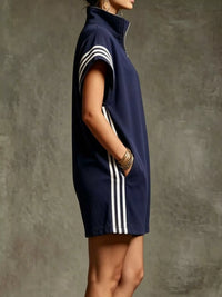 Navy sleeveless dress with white stripes on a textured gray background