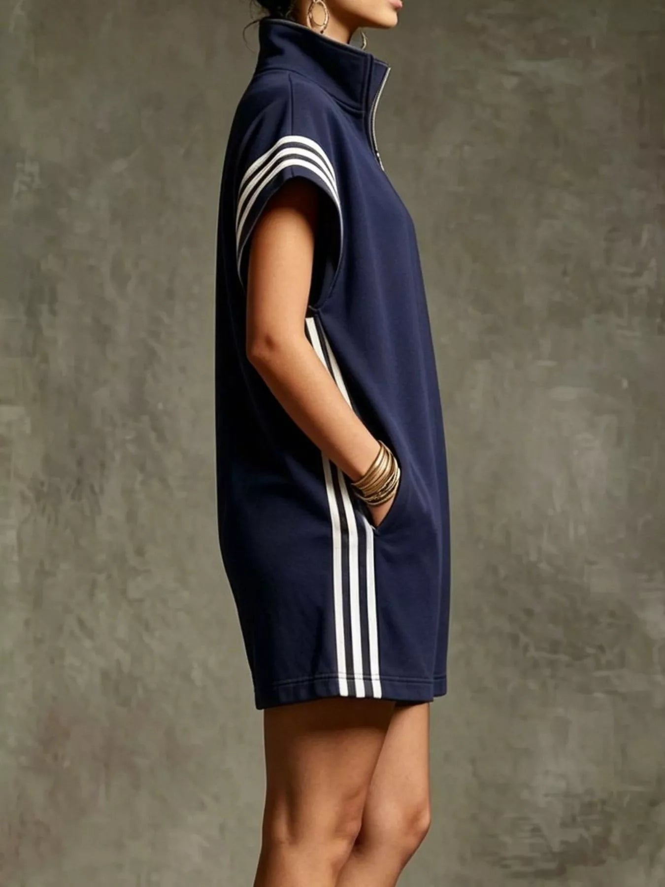 Navy sleeveless dress with white stripes on a textured gray background