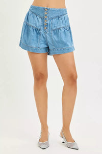 Light blue denim shorts worn by a person on a white background