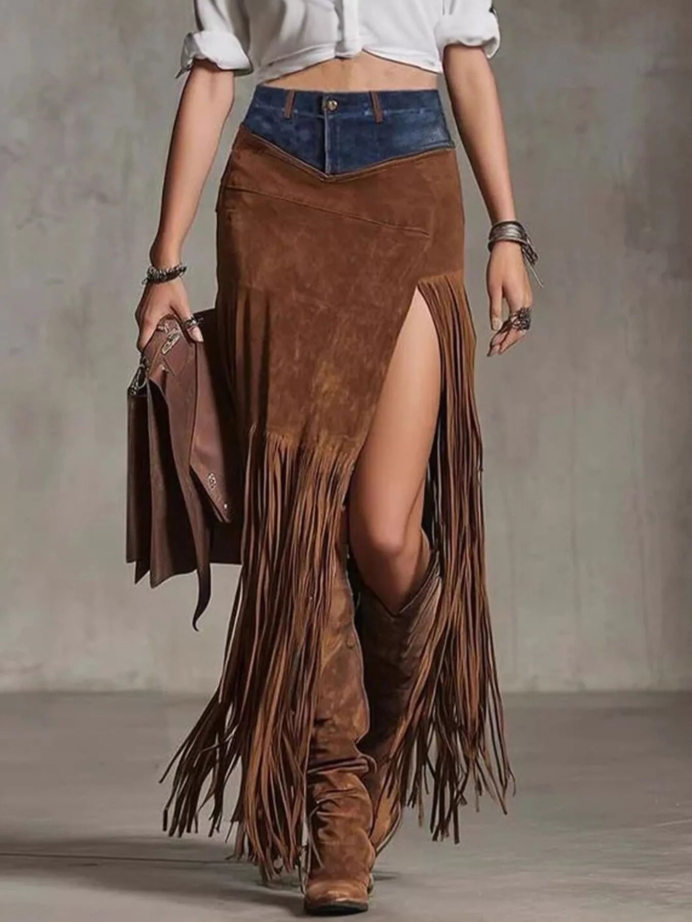Person wearing a brown suede fringe skirt with a plain background