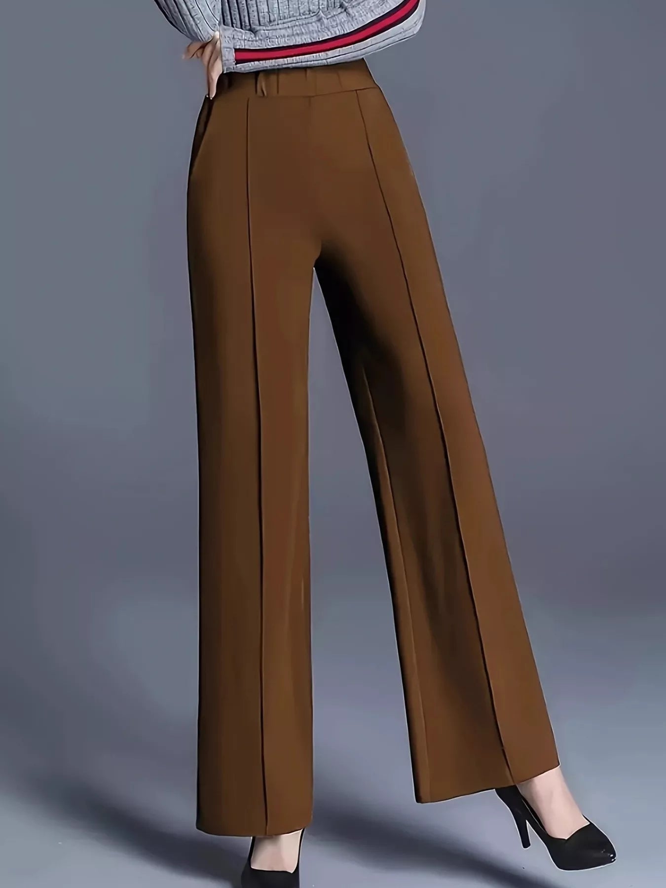 Brown wide-leg pants worn by a person on a gray background