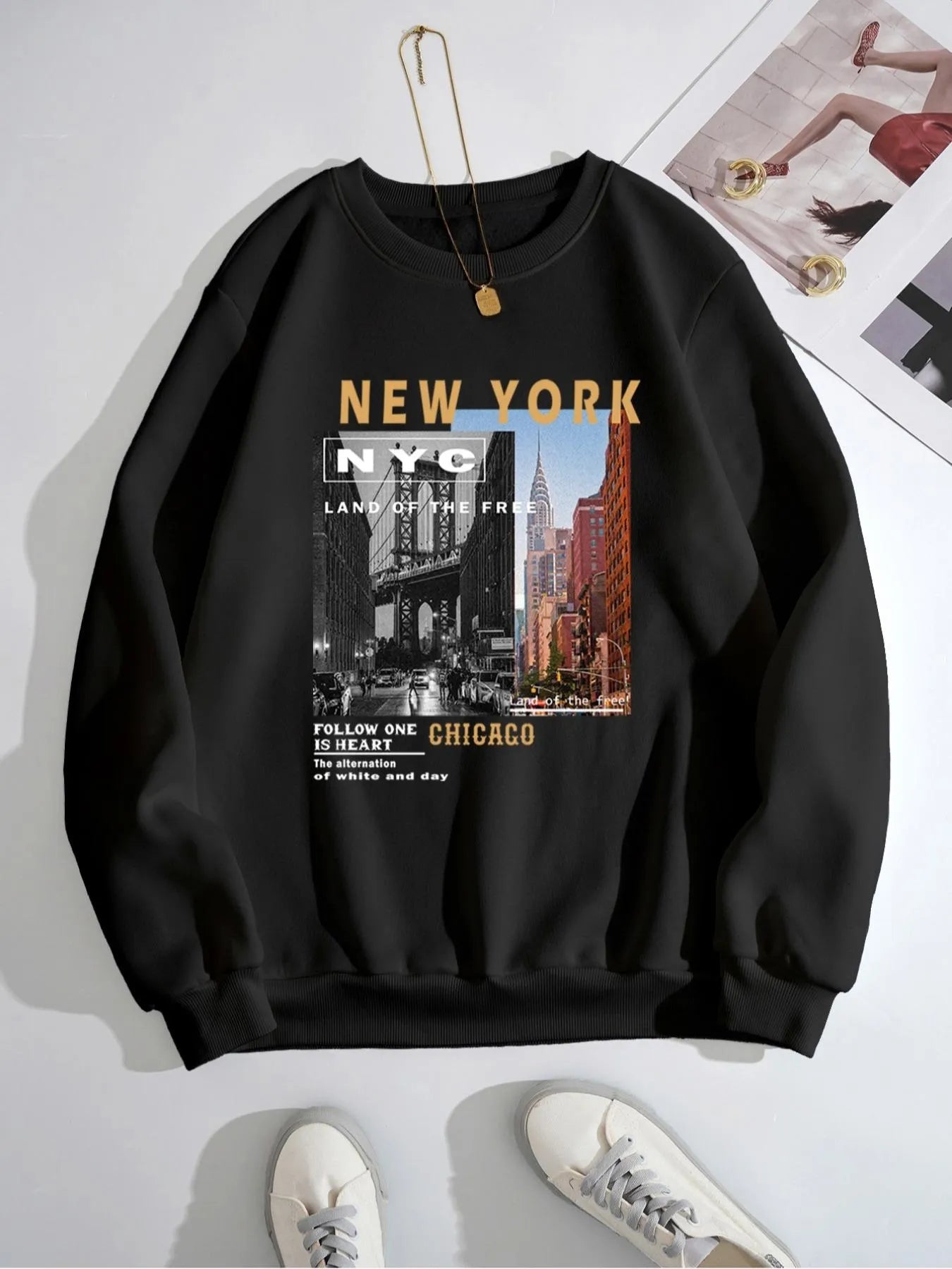 Black sweatshirt with New York and Chicago text and graphics on a white background