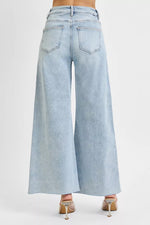 Light blue wide-leg jeans on a white background