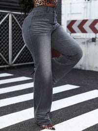 Person wearing gray flared jeans on a crosswalk