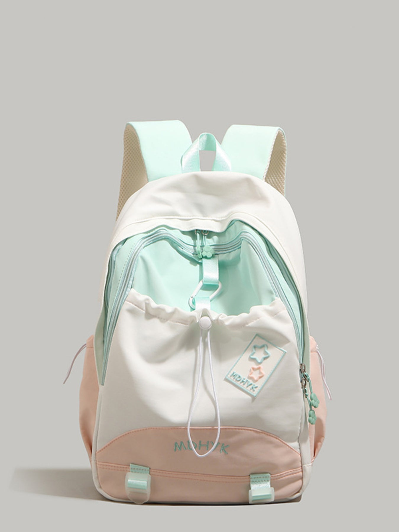 White and light green backpack with a drawstring on a gray background