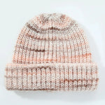 Knitted beanie with a striped pattern on a light background