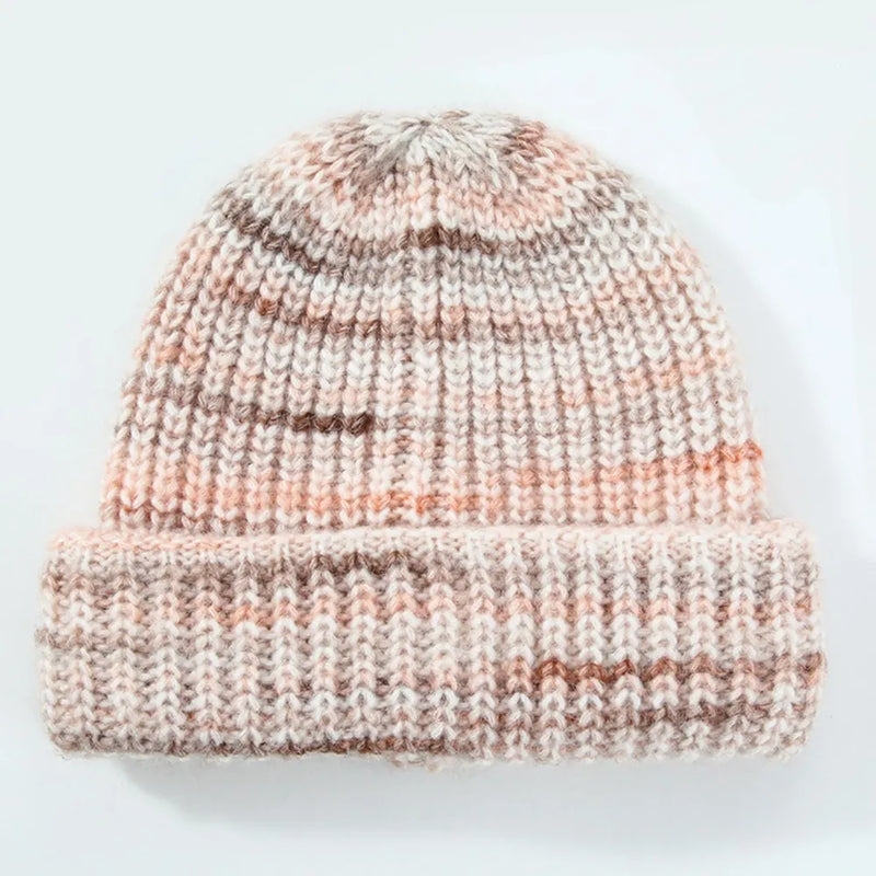 Knitted beanie with a striped pattern on a light background