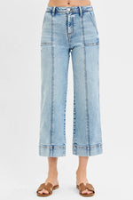 Light blue denim jeans on a white background