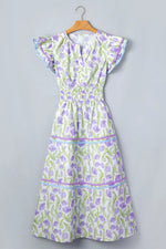 Floral dress on a hanger against a gray background