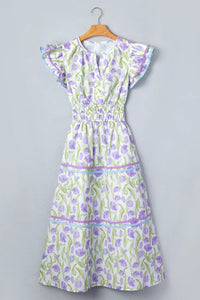 Floral dress on a hanger against a gray background
