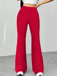 Red wide-leg pants worn by a person on a plain background