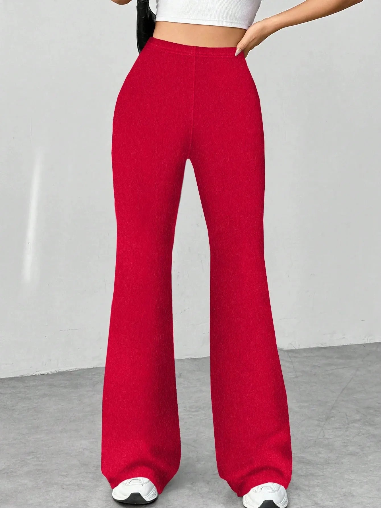 Red wide-leg pants worn by a person on a plain background
