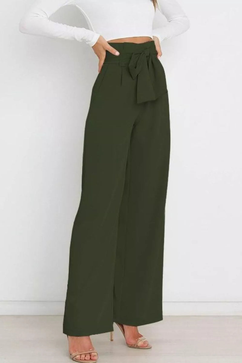 Green wide-leg pants worn by a person against a white background
