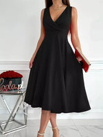 Black sleeveless dress worn by a person on a white background
