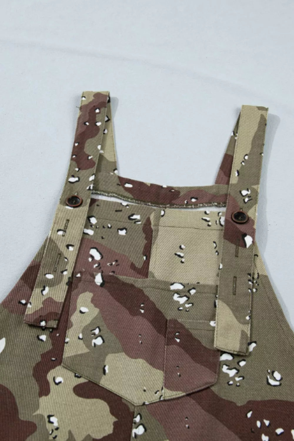 Camouflage apron with bullet holes on a white background
