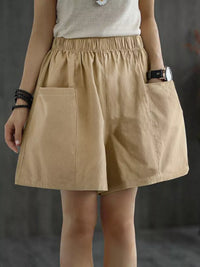 Person wearing a beige skirt with a plain background