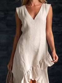 Woman wearing a white dress with a blurred dark background