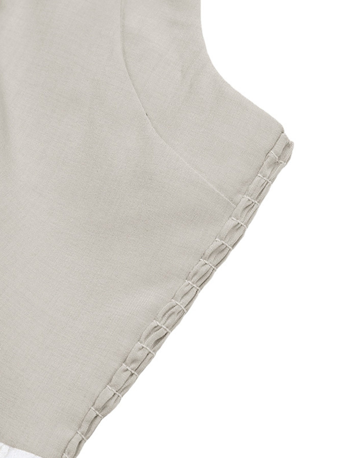 Close-up of a light gray fabric with textured edge on a white background