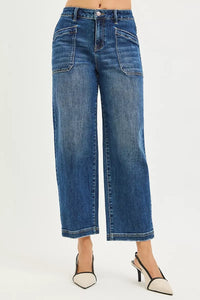 Blue jeans worn by a person on a white background