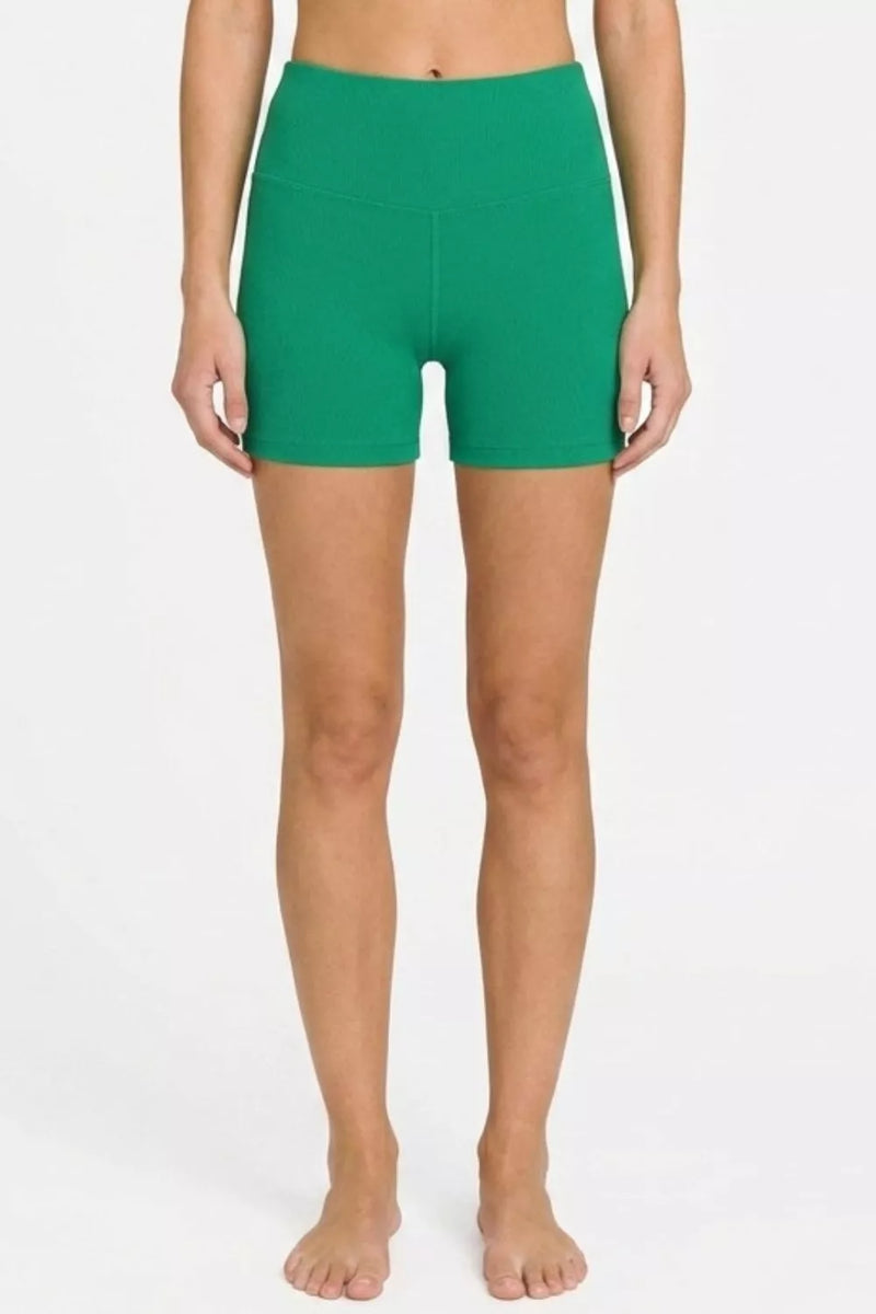 Person wearing green shorts on a white background